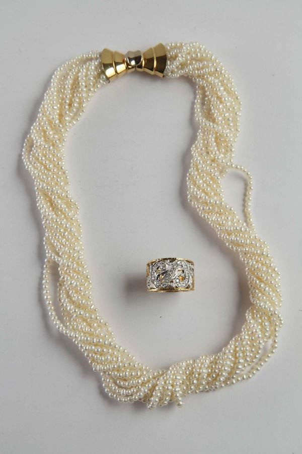Lotto composto da anello a fascia in oro bianco e giallo con diamanti e collana di perle