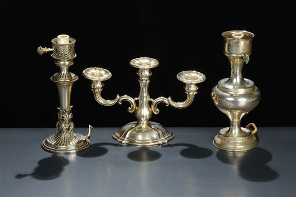 Tre candelieri diversi di cui due in argento