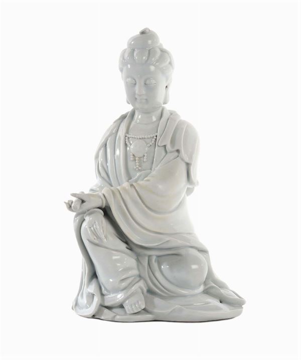 Blanc de Chine Dehau porcelain Guanyin sitting with scroll in her hands, China, Qing Dynasty, 18th century