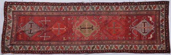 Tappeto caucasico a fondo rosso con medaglioni sovrapposti e bordura bianca, fine XIX secolo