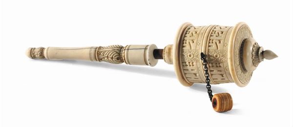 Ivory and silver prayer wheel, Tibet, 19th century,  carved decoration with Tibetan inscriptions on the cylinder and the reel handles, h cm 32