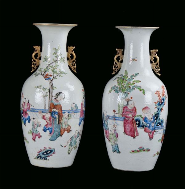 Pair of Famille Rose porcelain vases, China, Qing Dynasty, end 19th century polychrome decoration with female figures and children, h cm