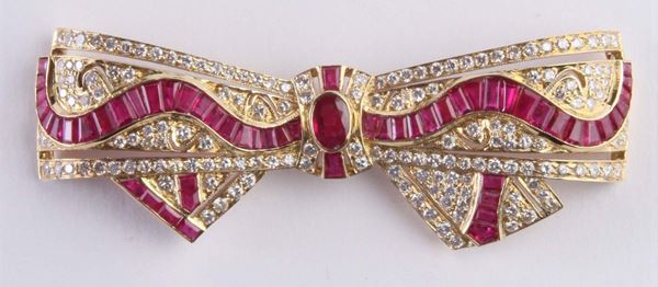 A ruby and diamond bow brooch