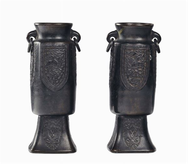 Two small bronze vases with archaic motives, China, Ming Dynasty, 17th century Handles in the shape of rings, square base decorated with phoenixes and vegetable elements within reserves, cm 18,5