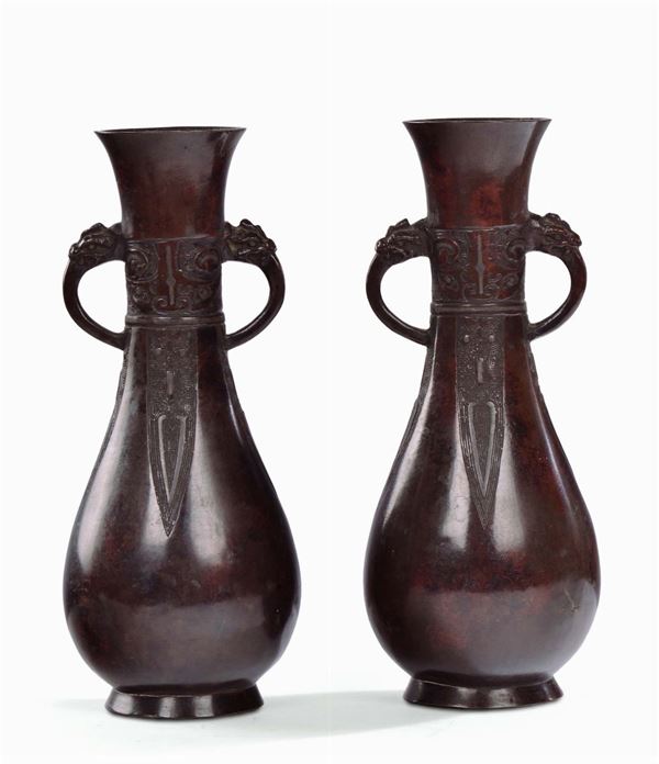 Pair of bronze vases, archaic shape, China, Ming Dynasty, 17th century handles in the shape of elephant trunk and carved decoration, h cm 27