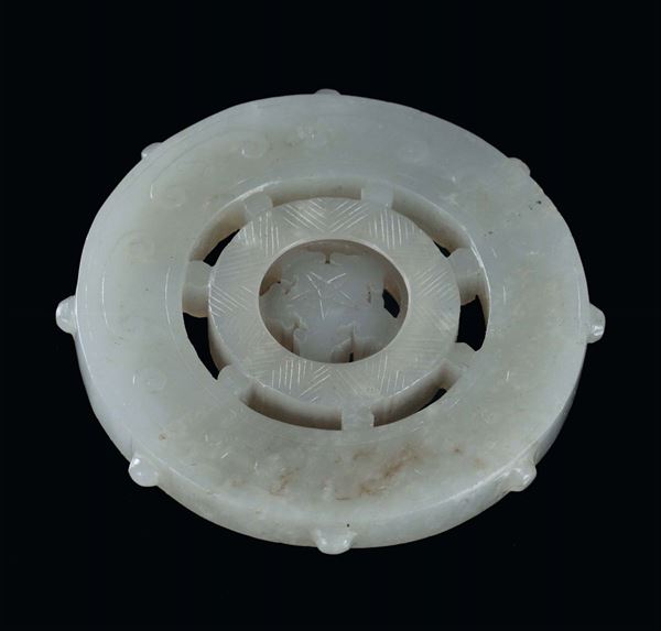White fretworked jade disk in the shape of helm, China, Qing Dynasty, 19th century diameter cm 5,5