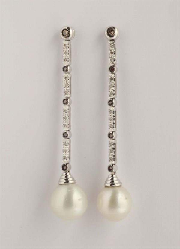 A pair of pearl and diamond pendent earrings