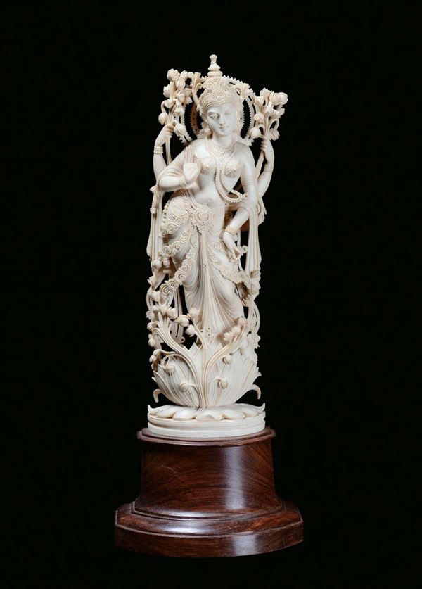 An ivory sculpture representing a divinity dancing on a lotus flower, India, early 20th century