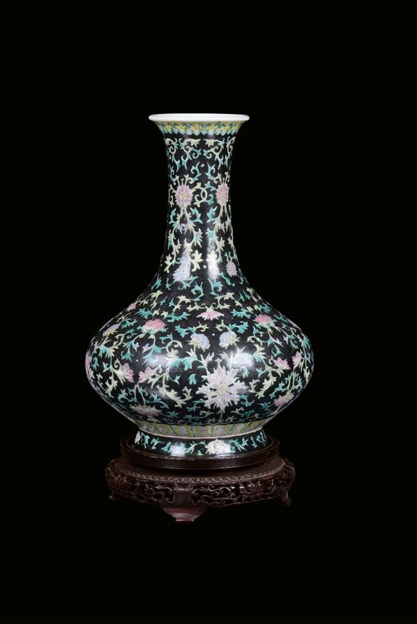 A polychrome porcelain vase, China, Qing Dynasty, end 19th centuryfloral decoration on black background, apocryphal Qianlong mark