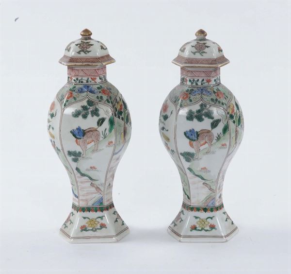 A pair of small polychrome porcelain capped vases  , China, 19th century. Hexagonal base, decoration with imaginary animals and floral motives
