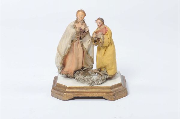 Due figure da presepe con abiti in stoffa