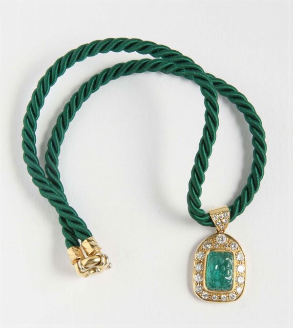 An emerald engraved and diamond pendant necklace
