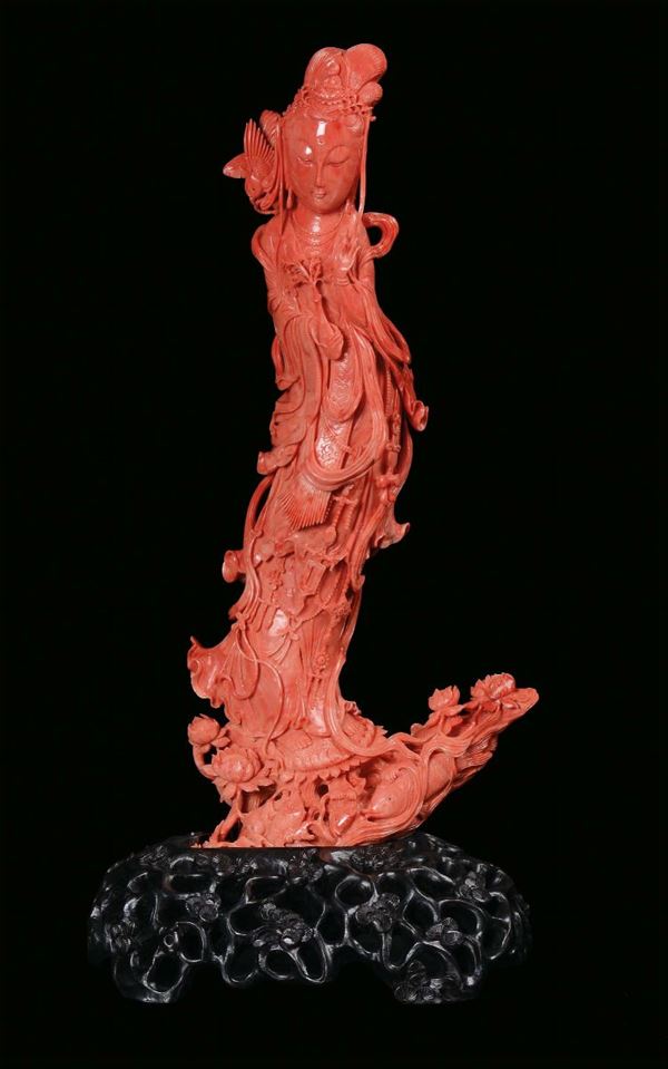 A large red coral sculpture representing a Guanyin, China, Qing Dynasty, 19th century