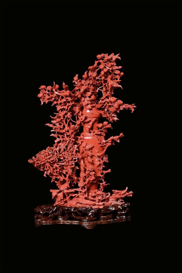 A red coral vase representing richly carved vegetation, fruit and birds, China, beginning 20th centur [..]