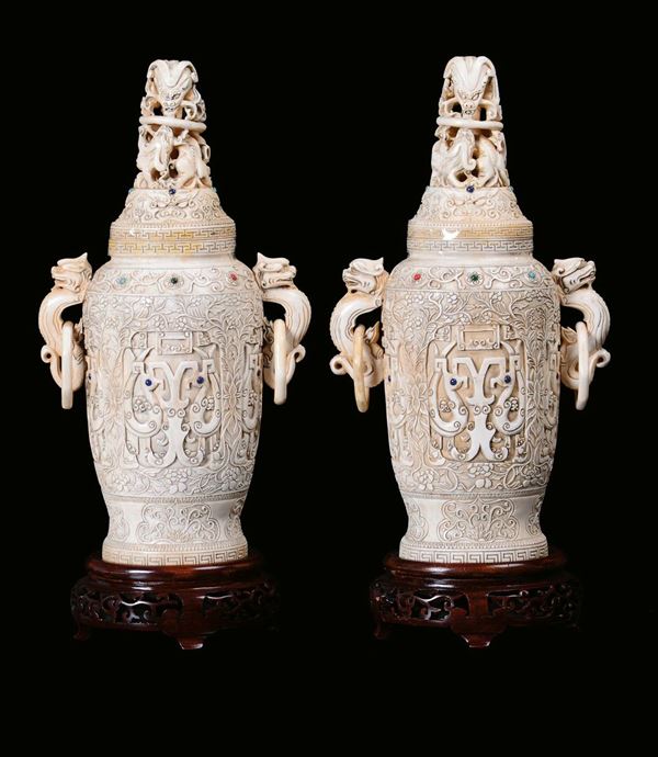 A pair of ivory vases sculpted with vegetable and floral motives, China, Qing Dynasty, 19th centuryApplication of gems, handles in the shape of imaginary animal