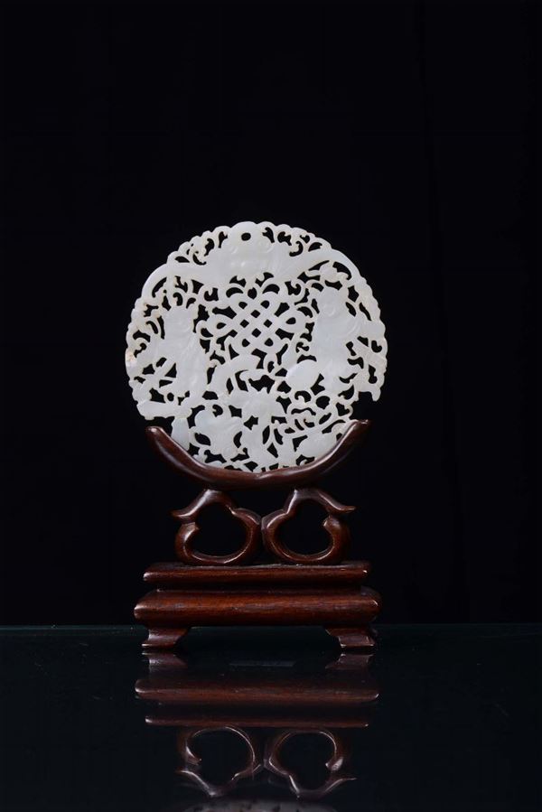 A white fretworked jade disk, China early 20th century