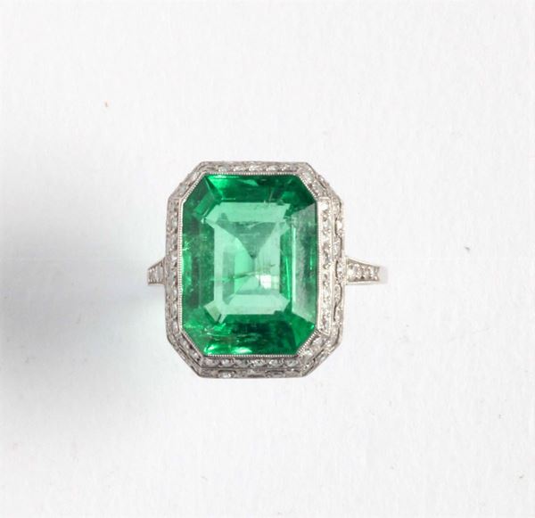 An emerald and diamond ring. 1920 circa