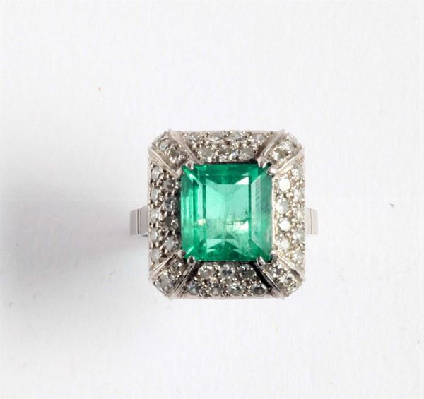 An emerald and diamond ring. 1940 circa