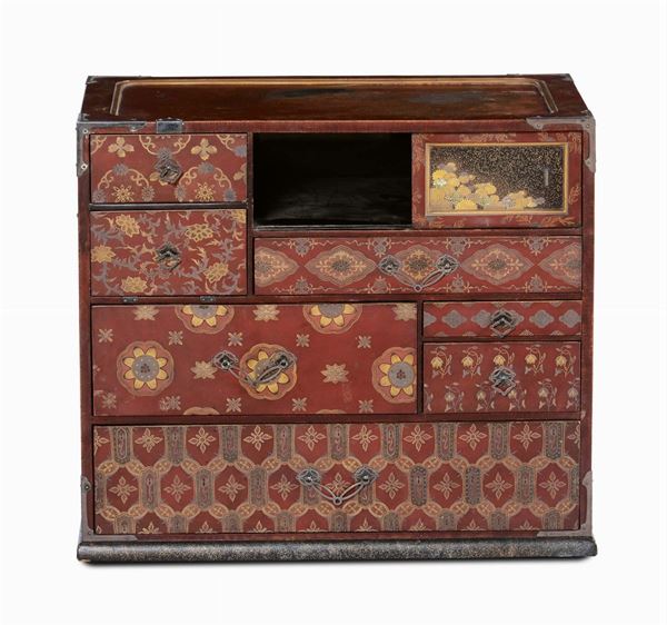A lacquered travel chest with small drawers, golden decoration on red background,  Japan 19th century