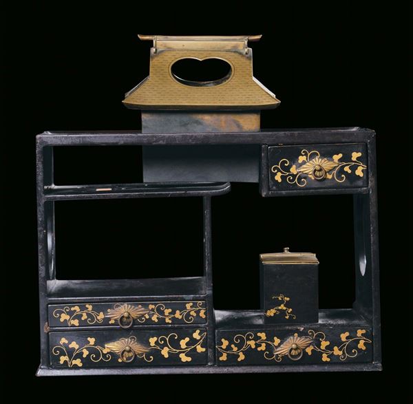 A small black and gold lacquered piece of furniture with two-sided drawers. Japan, 19th century
