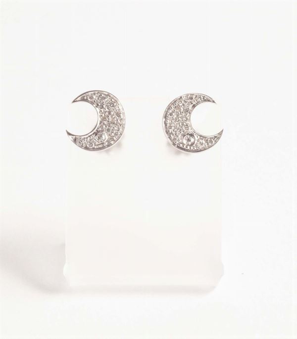 A pair of crescent diamond earrings