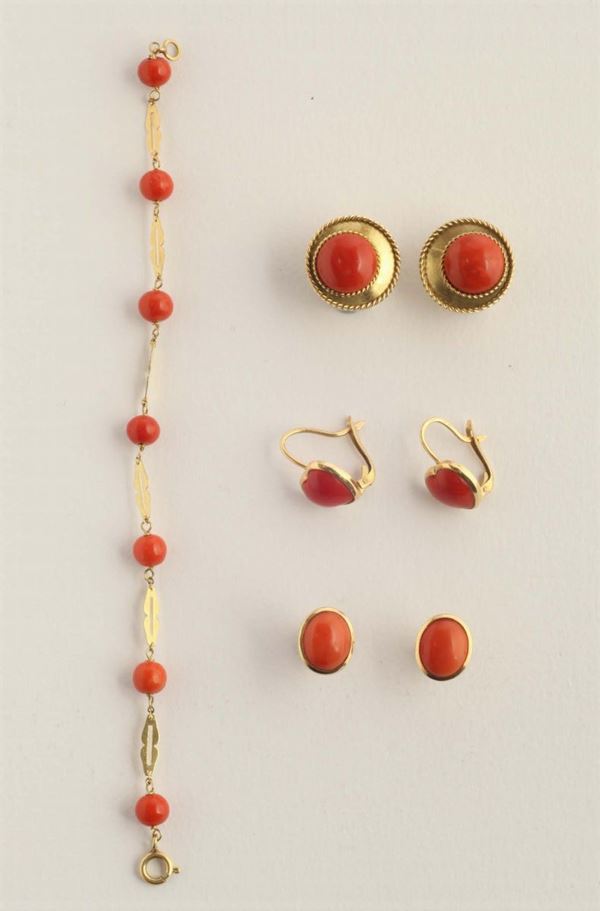A coral and gold bracelet and three pair of earrings