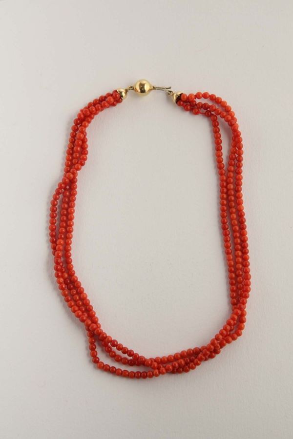 A coral necklace and gold clasp