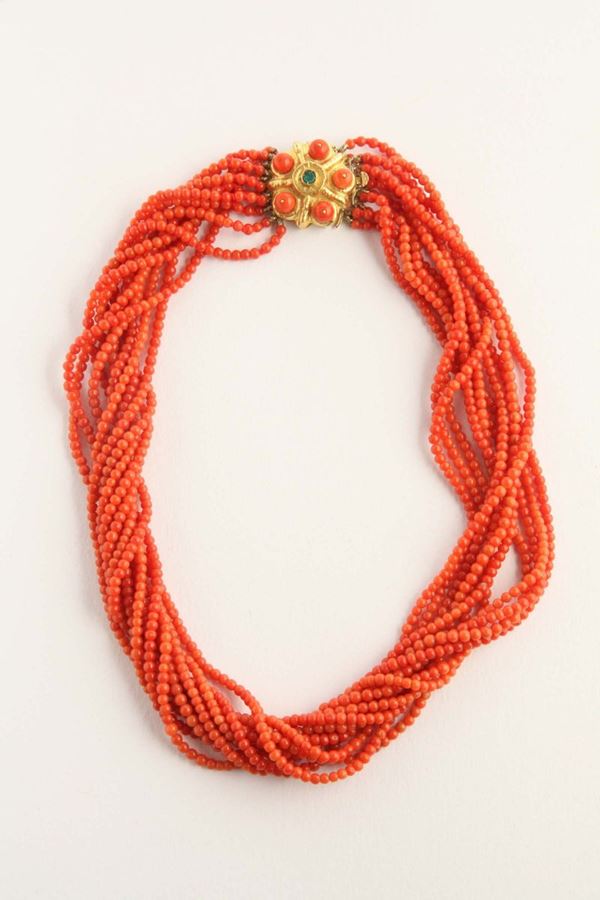 A coral necklace, emerald and gold clasp