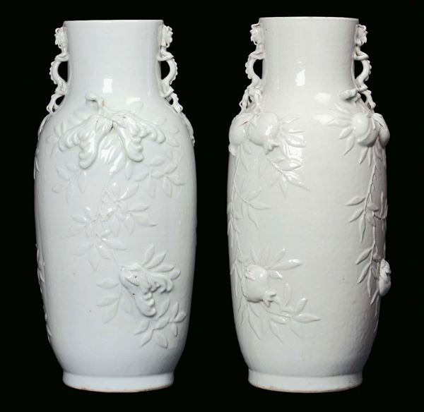 A pair of Blanc de Chine porcelain vases decorated with relief bloomy branches and pomegranate, China, Qing Dynasty, 19th century