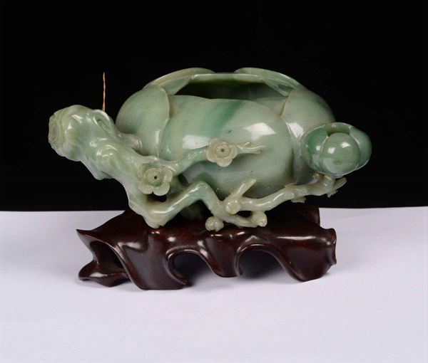 A small jadeite brush-rinse in the shape of magnolia, China, Qing Dynasty, 19th century wooden base