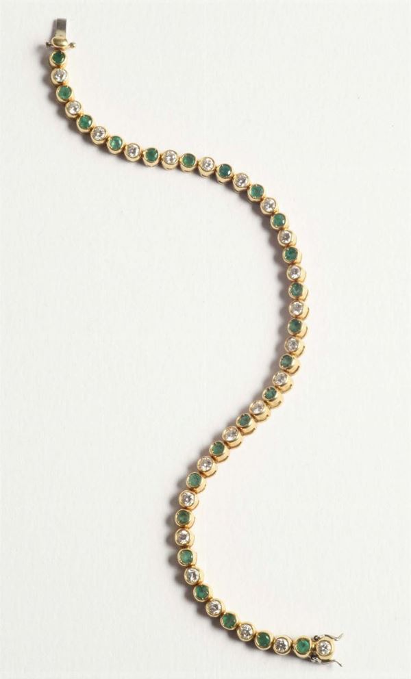A diamond and emerald line bracelet
