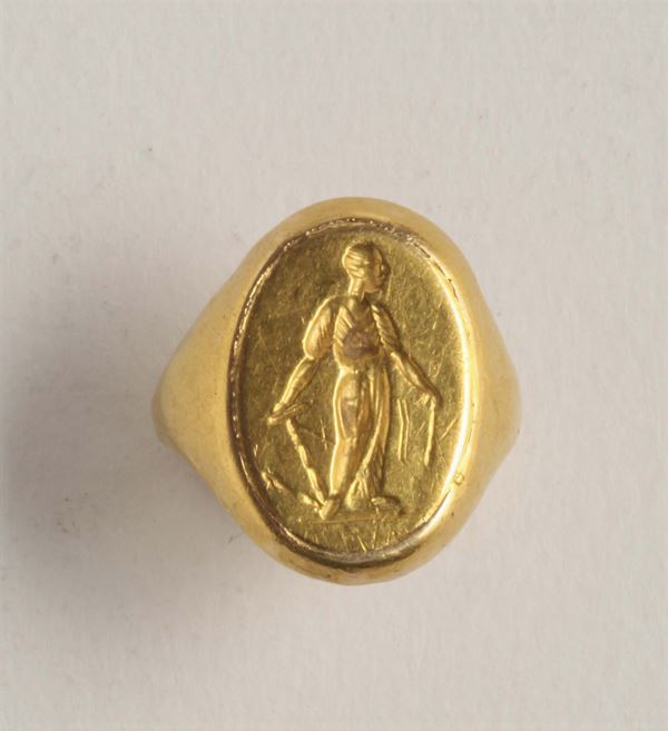 A gold ring is engraved with the figure of a man