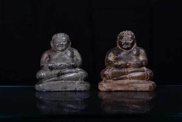 A pair of lava stone Buddha