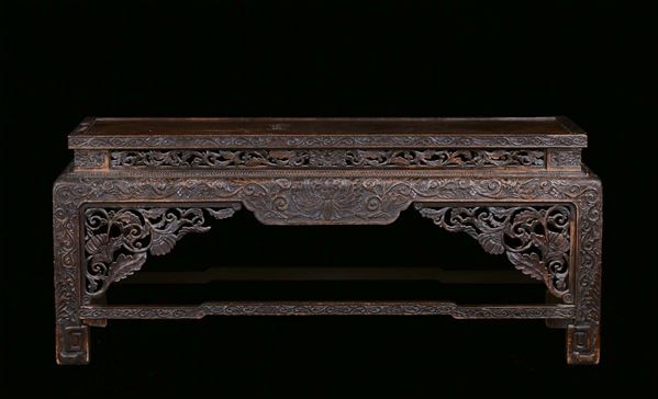 A small wood bench carved and fretworked with vegetable motives, China, Qing Dynasty, 19th century