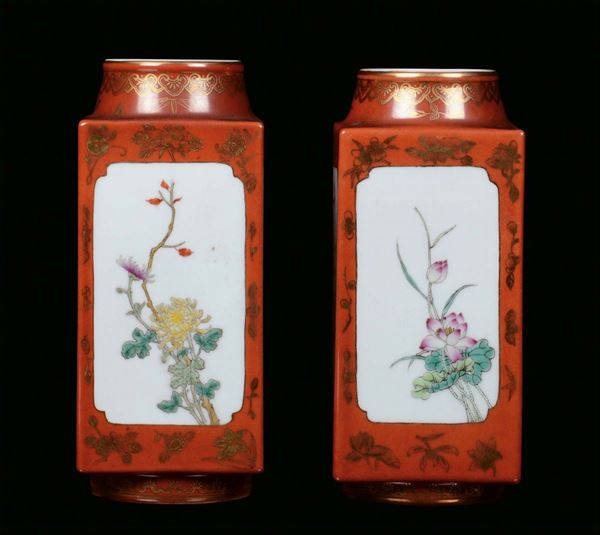 A pair of porcelain vases decorated in polychrome in the colours of the Famille Rose, China, Republic, 20th centurySquared section with golden decoration on red background and floral motives
