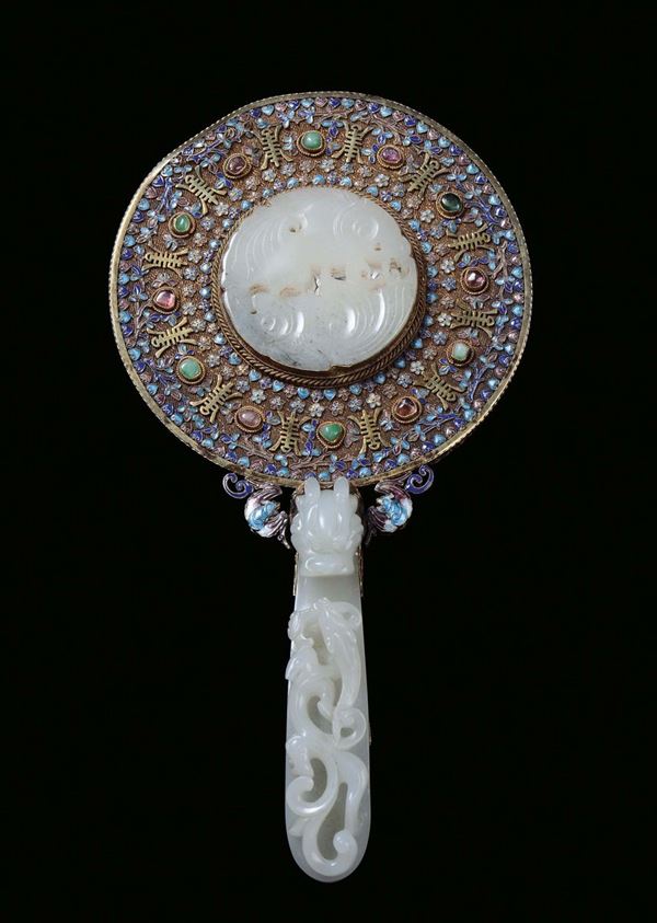 A small mirror with gilt silver frames with enamels and gems, handle and rosettes in white jade with dragon motives, China, 19th century