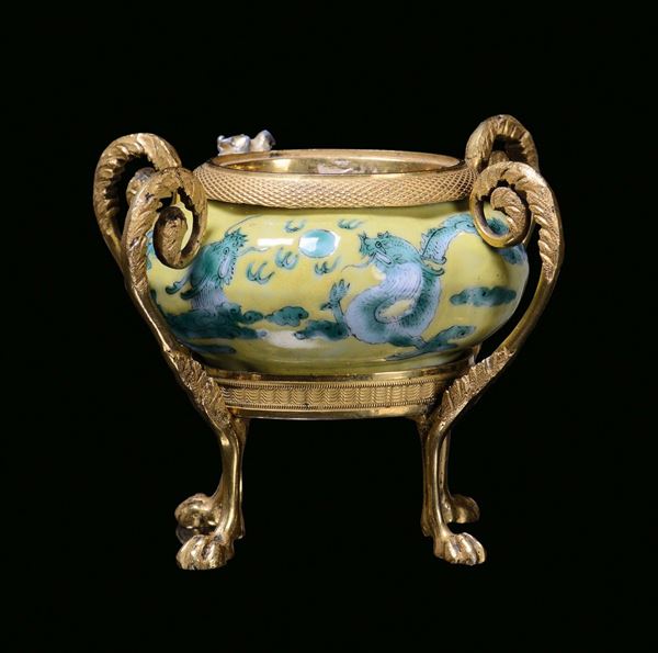 A yellow porcelain inkpot decorated with relief dragons, China, Qing Dynasty, Daoguang Period (1821-1850)Coeval gilt bronze mounting
