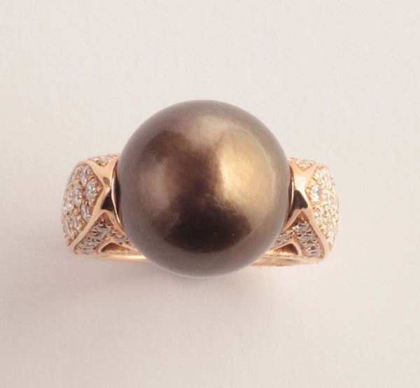 A cultured pearl and diamond ring