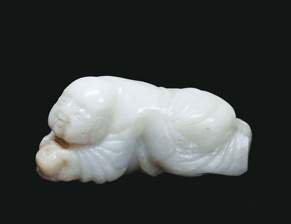 A small jade lying down oriental figure, China, Qing Dynasty, 19th century