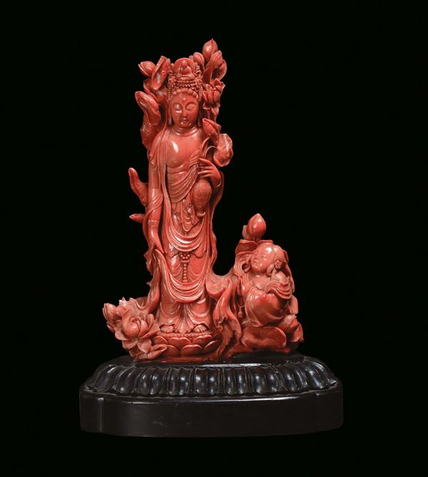 A rare red coral group representing a Guanyin with finely sculpted girl, China, Qing Dynasty, 19th century 