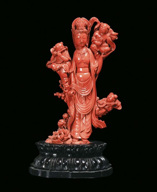 A rare red coral group representing Guanyin with musicians finely sculpted, China, Qing Dynasty, beginning 20th century