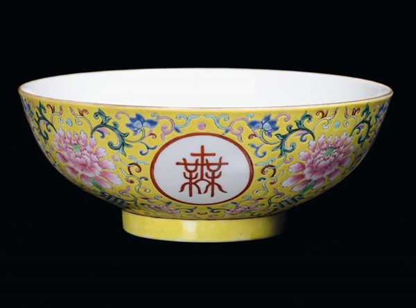 A porcelain bowl with yellow background in the colours of the Pink Family, with ideograms within reserves, China, Qing Dynasty, Jiaqing Period (1796-1820)Mark and the period