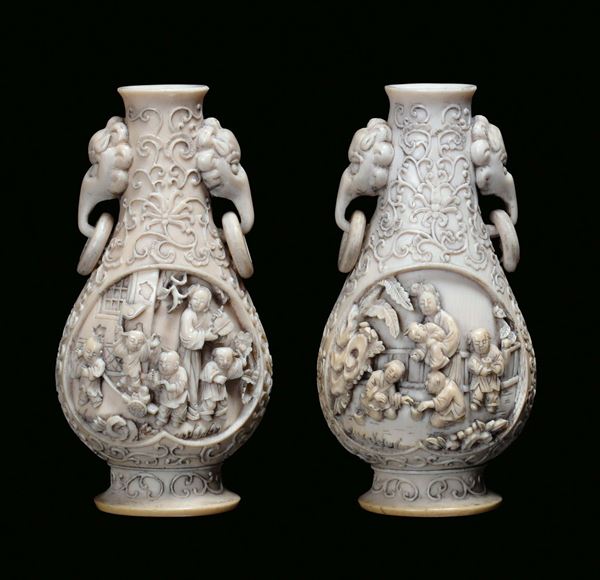 A pair of ivory vases with handles in the shape of elephant and decoration with finely sculpted figures, China, Qing Dynasty Qianlong mark