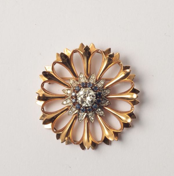 A diamond and gold brooch/pendant. Accompanied by