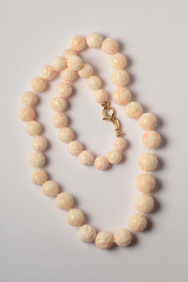 A coral carving necklace, gold and diamond clasp