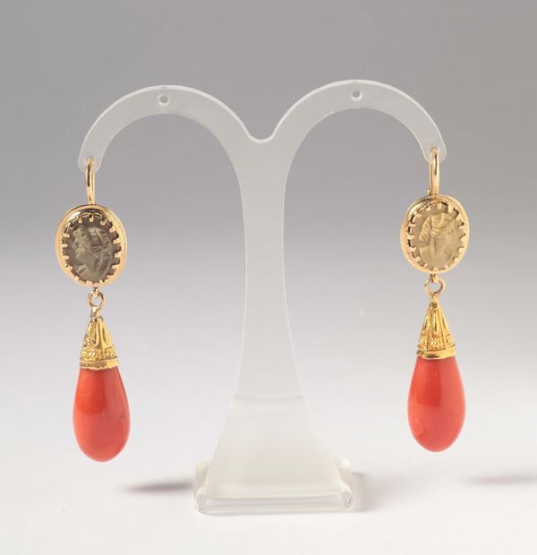 A pair of coral and lava pendent earrings