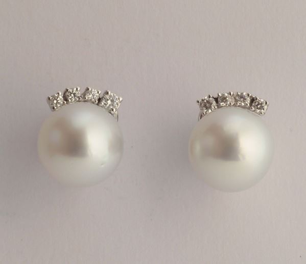 A pair of cultured pearl with a four diamonds earrings