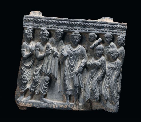 A fragment of a stone bas relief with a group of figures, Ghandara, 2nd-3rd century