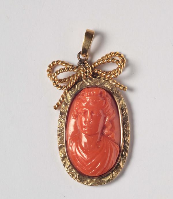 A coral cameo pendant, gold mount