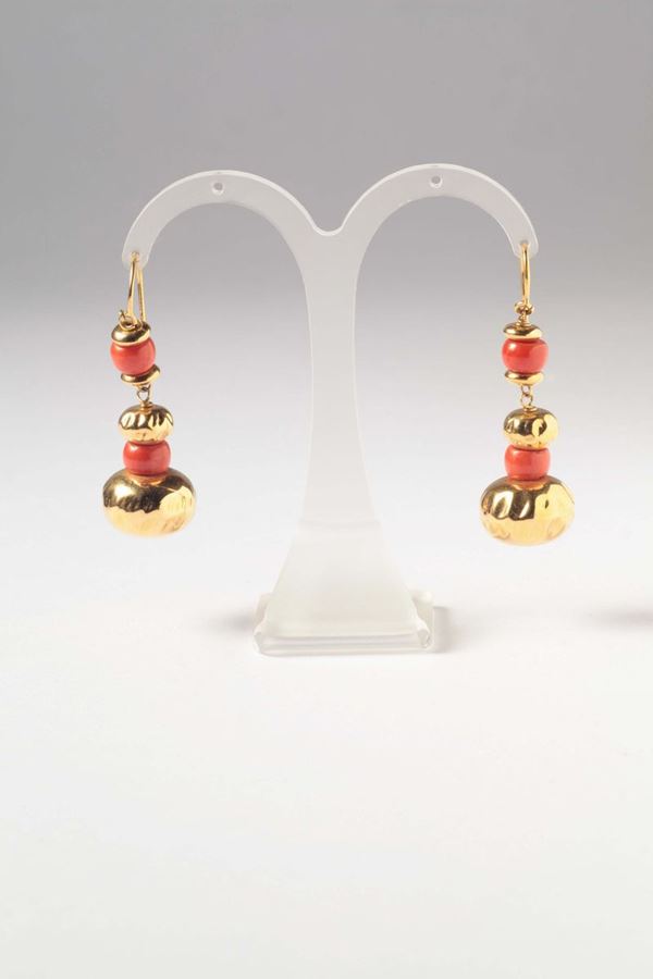 A pair of coral and gold earrings